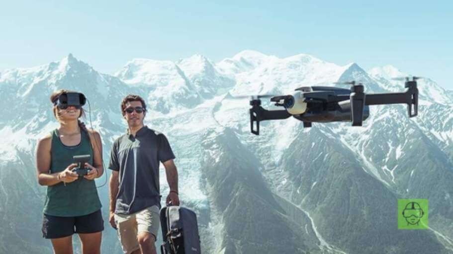 a man and woman with luggage and a drone flying over mountains - drone-with-vr-headsets-vskel